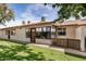 Well-maintained backyard with green lawn, lush trees, and a view of the home's exterior at 8160 E Keats Ave # 339, Mesa, AZ 85209