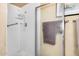 Bright bathroom featuring a glass-enclosed shower, neutral tiling, and convenient grab bar at 8160 E Keats Ave # 339, Mesa, AZ 85209