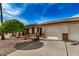Inviting exterior view of a home showcasing a two-car garage and a quaint front patio at 8160 E Keats Ave # 339, Mesa, AZ 85209