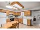 Efficient kitchen with wooden cabinets, white appliances, and tile flooring at 8160 E Keats Ave # 339, Mesa, AZ 85209