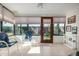 Enclosed sunroom featuring tile floors, multiple windows, and a door that opens to the backyard at 8160 E Keats Ave # 339, Mesa, AZ 85209