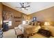 Bedroom with plush bed, curtains, ceiling fan, and neutral color scheme at 8272 S Pecan Grove Cir, Tempe, AZ 85284