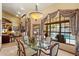 Dining room with glass table set for six and large windows overlooking the pool at 8272 S Pecan Grove Cir, Tempe, AZ 85284