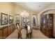 Formal dining room featuring a chandelier, elegant table setting, rich wood accents, and classic décor elements at 8272 S Pecan Grove Cir, Tempe, AZ 85284