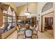 Formal dining room featuring vaulted ceilings, a glass table, seating for six, and elegant drapery at 8272 S Pecan Grove Cir, Tempe, AZ 85284