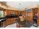 Kitchen with a center island, stainless steel appliances, wine storage, and custom wood cabinets at 8272 S Pecan Grove Cir, Tempe, AZ 85284