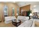 Spacious living room with vaulted ceilings, large arched windows, neutral-toned walls, and classic furniture arrangement at 8272 S Pecan Grove Cir, Tempe, AZ 85284