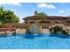 Beautiful pool with water feature, complemented by manicured landscaping and blue, sunny skies at 8272 S Pecan Grove Cir, Tempe, AZ 85284