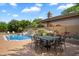A refreshing pool is surrounded by lush landscaping and a patio dining set at 8272 S Pecan Grove Cir, Tempe, AZ 85284