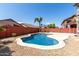 Serene backyard with pool, mature trees, and ample space for outdoor enjoyment at 1051 E Julie Ave, San Tan Valley, AZ 85140