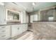 A bathroom showcases white cabinets, granite countertops, and a tiled shower with glass doors at 1051 E Julie Ave, San Tan Valley, AZ 85140