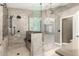 Luxurious walk-in shower featuring decorative tile, glass enclosure, and modern fixtures at 1051 E Julie Ave, San Tan Valley, AZ 85140