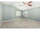 A bedroom with light gray walls, carpet floors, and a ceiling fan at 1051 E Julie Ave, San Tan Valley, AZ 85140