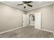 Spacious bedroom with ceiling fan and an arched entry to the hall and bathroom at 1051 E Julie Ave, San Tan Valley, AZ 85140