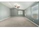 A spacious bedroom with light gray walls, carpet floors, and a ceiling fan at 1051 E Julie Ave, San Tan Valley, AZ 85140