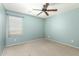 Well-lit bedroom featuring a window and ceiling fan for enhanced comfort at 1051 E Julie Ave, San Tan Valley, AZ 85140