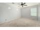 Bright bedroom with a ceiling fan and natural light, perfect for a relaxing retreat at 1051 E Julie Ave, San Tan Valley, AZ 85140