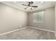 Inviting bedroom with a ceiling fan and large window, offering a cozy retreat at 1051 E Julie Ave, San Tan Valley, AZ 85140