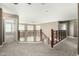 Upstairs bonus room with decorative wrought iron and wood staircase overlooking the space below at 1051 E Julie Ave, San Tan Valley, AZ 85140