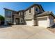Attractive two-story home showcasing a three-car garage and inviting curb appeal with desert landscaping at 1051 E Julie Ave, San Tan Valley, AZ 85140