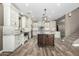 A kitchen showcases white cabinets, a dark wood island, and light wood-look floors at 1051 E Julie Ave, San Tan Valley, AZ 85140