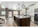 Spacious kitchen features a granite island, modern appliances, and dark wood-look floors at 1051 E Julie Ave, San Tan Valley, AZ 85140
