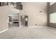 Expansive living area with neutral carpeting and views of the fireplace and an adjacent room with a powder room at 1051 E Julie Ave, San Tan Valley, AZ 85140