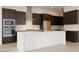 Contemporary kitchen with a large center island, stainless steel appliances, and dark cabinets at 1336 E Cherrywood Pl, Chandler, AZ 85249