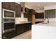 Close up view of the kitchen with sleek stainless steel appliances and dark cabinetry at 1336 E Cherrywood Pl, Chandler, AZ 85249