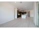 Open concept living room featuring a modern kitchen and light colored tile floors at 1336 E Cherrywood Pl, Chandler, AZ 85249