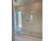 Contemporary shower showcases stylish tile work, glass enclosure, and a convenient built-in window at 1336 E Cherrywood Pl, Chandler, AZ 85249