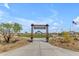 View of Goldstone Park entrance featuring a well-maintained lawn, walkway, seating, and American flag at 1380 W Ridge Rd, Apache Junction, AZ 85120