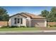 Charming single-story home featuring a tiled roof, two-car garage, and landscaped front yard at 1380 W Ridge Rd, Apache Junction, AZ 85120