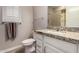 Well-lit bathroom with granite countertop, white cabinetry, and a tiled shower at 14640 W Dahlia Dr, Surprise, AZ 85379