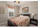 Bedroom with carpet, ceiling fan, and window with shutters at 14640 W Dahlia Dr, Surprise, AZ 85379