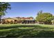 Expansive home with manicured lawn, covered patio, and colorful architecture at 14640 W Dahlia Dr, Surprise, AZ 85379