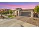 Charming single-story home with well-manicured lawn, beautiful brick driveway, and neutral stucco exterior at 14640 W Dahlia Dr, Surprise, AZ 85379