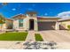 Charming single-story home with well-manicured lawn, beautiful brick driveway, and neutral stucco exterior at 14640 W Dahlia Dr, Surprise, AZ 85379