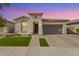 Charming single-story home with well-manicured lawn, beautiful brick driveway, and neutral stucco exterior at 14640 W Dahlia Dr, Surprise, AZ 85379