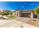 Charming single-story home with well-manicured lawn, beautiful brick driveway, and neutral stucco exterior at 14640 W Dahlia Dr, Surprise, AZ 85379