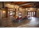 Spacious community space with hardwood floors, a long table and comfortable chairs at 14640 W Dahlia Dr, Surprise, AZ 85379