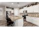 Modern kitchen with granite counters, white cabinets, stainless steel appliances, and decorative backsplash at 14640 W Dahlia Dr, Surprise, AZ 85379