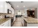 Modern kitchen with granite counters, white cabinets, stainless steel appliances, and decorative backsplash at 14640 W Dahlia Dr, Surprise, AZ 85379