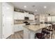 Modern kitchen with granite counters, white cabinets, stainless steel appliances, and decorative backsplash at 14640 W Dahlia Dr, Surprise, AZ 85379