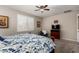 A peaceful main bedroom includes carpeting, a ceiling fan, and neutral décor, perfect for relaxation at 14640 W Dahlia Dr, Surprise, AZ 85379