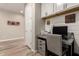Bright office with a workspace, drawers, overhead cabinets, and modern decor at 14640 W Dahlia Dr, Surprise, AZ 85379