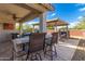 Outdoor kitchen featuring a built-in grill and bar area perfect for entertaining in a covered patio at 14640 W Dahlia Dr, Surprise, AZ 85379