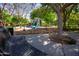 Quiet park bench near a playground offers relaxation amidst scenic greenery at 14640 W Dahlia Dr, Surprise, AZ 85379