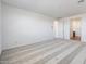 Large bedroom features neutral walls, plush carpeting, and an open doorway leading to an ensuite bathroom at 14739 W El Cortez Pl, Surprise, AZ 85387