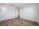 A bedroom with light-colored wood-look flooring and neutral walls offers a clean and calming aesthetic at 14739 W El Cortez Pl, Surprise, AZ 85387
